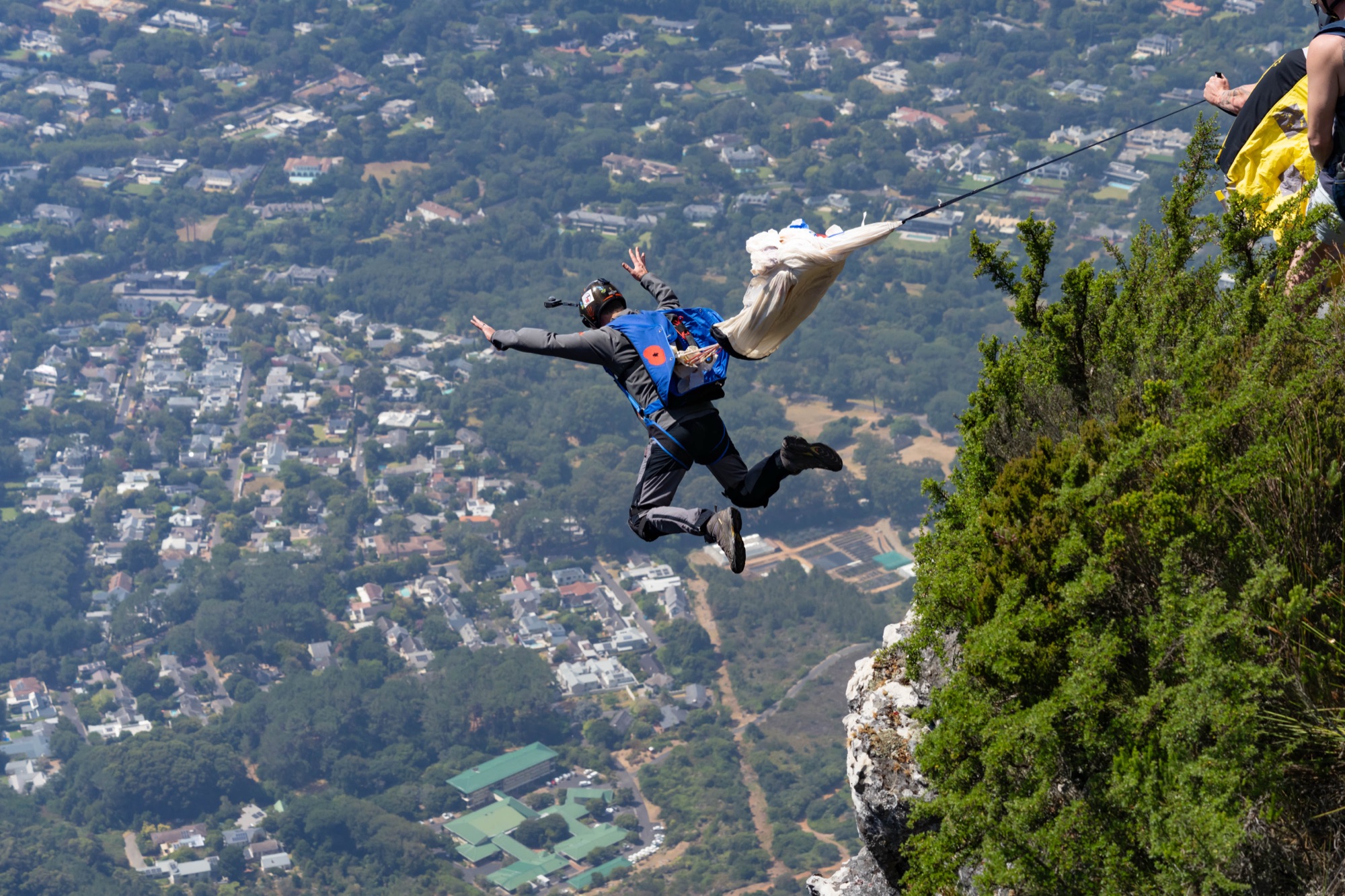 Birds Eye View participant beginning a BASE jump above Cape Town