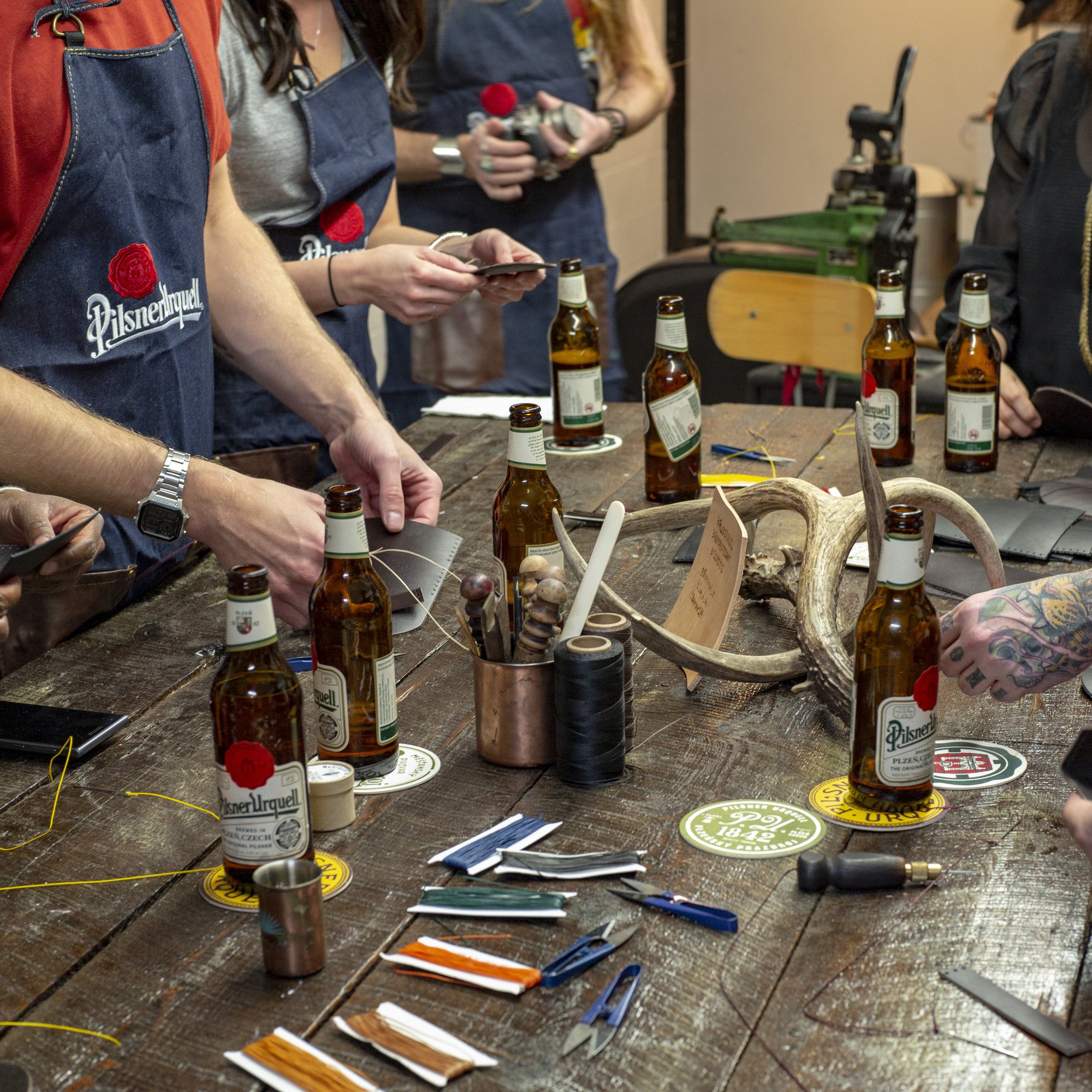 Pilsner Urquell bottles and live craft tools at the activation